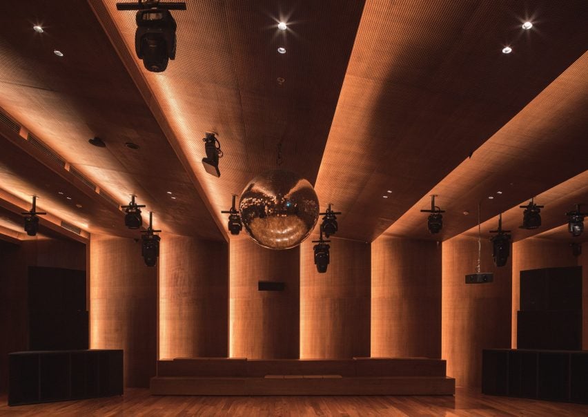 A disco ball with a diameter of one meter hangs above a sprung dance floor