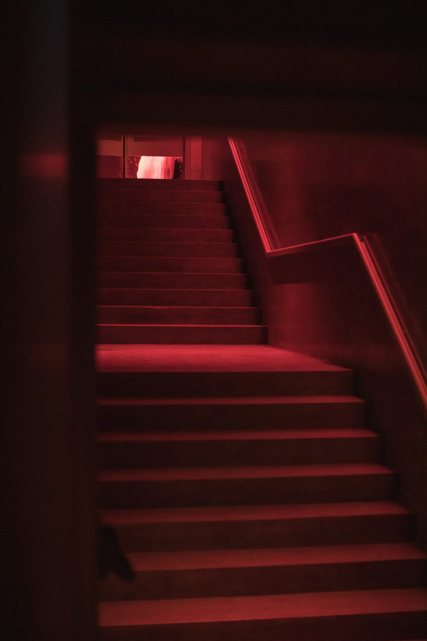 Red-lit stairs lead down to the dance floor