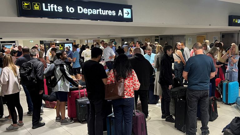 Passengers queue in front of Terminal 1. Image: Reuters