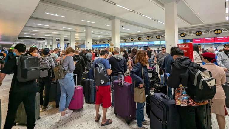 Passengers queue at the airport after a power outage. Image: Chris Shaw/Reuters