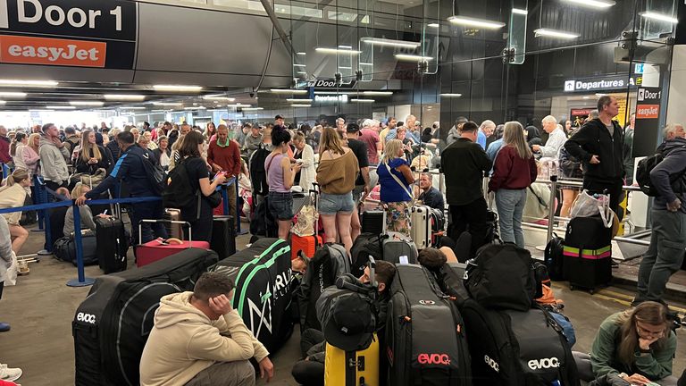 Passengers queue in front of Terminal 1. Image: Reuters