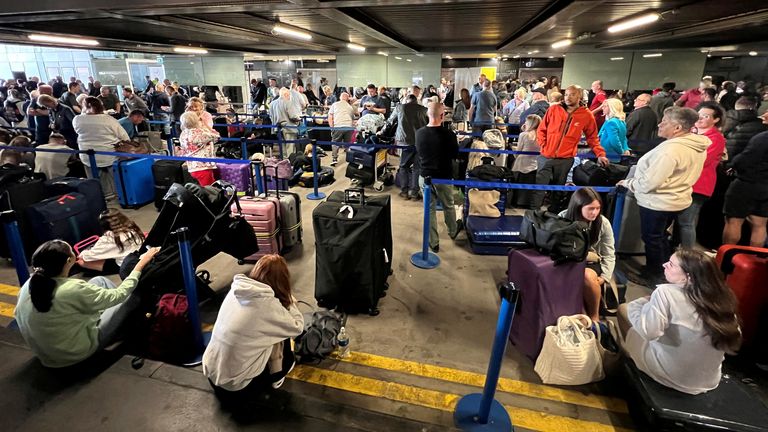 Passengers queue in front of Terminal 1. Image: Reuters