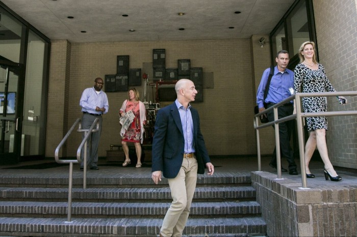 Jeff Bezos outside the Washington Post offices with former publisher Katharine Weymouth in 2013