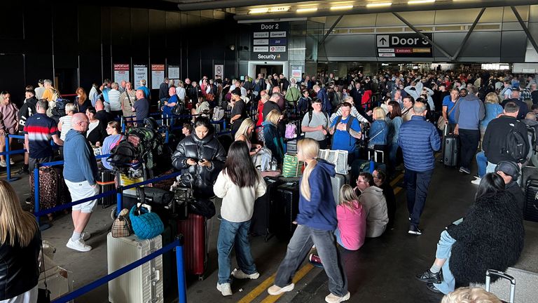 Passengers queue in front of Terminal 1. Image: Reuters